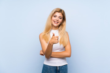 Teenager girl over isolated blue background thinking