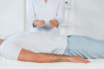 Wall Mural - female healer with hands above body of man