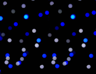 Wall Mural - Blue small circles abstract blurred and bokeh of LED party light bubs reflection lighting on black background. It's beautiful look like the stars in the night sky.