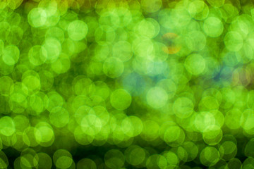 Wall Mural - Background and wallpaper green abstract with blurred and bokeh of LED light bubs reflection on black background.