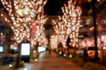 Wall Mural - Closeup blurred and bokeh of pink LED refection lighting decorate on trees in Valentines day with city night life in Osaka, Japan.