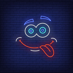 Sticker - Playful emoticon showing tongue neon sign. Face expression, joy, emotion design. Night bright neon sign, colorful billboard, light banner. Vector illustration in neon style.