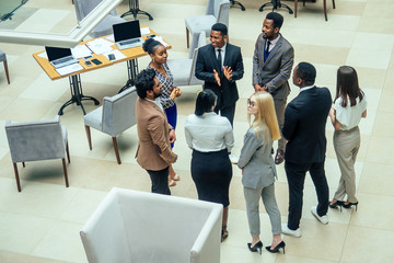 Wall Mural - Asian business person in multiracial. Diversity business people form by different races, Indian, Malay, Indonesian, Chinese and African in modern room shopping mall