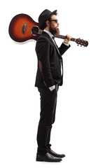 Wall Mural - Man carrying an acoustic guitar on his shoulder