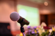 © nattanan - Microphone over the blurred business forum Meeting or Conference Training Learning Coaching Room Concept, Blurred background.