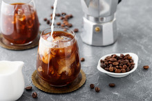 Summer Drink Iced Coffee Or Caffe Latte In A Glass With Milk And Coffee Beans.