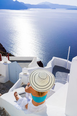 Luxury travel vacation woman looking at view on Santorini island