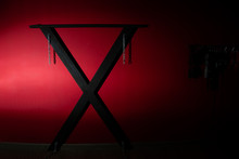  SM Cross Or Andreaskreuz Is Used In The BDSM Scene On Red Background