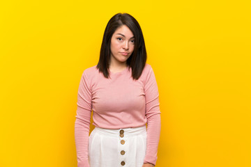 Young Mexican woman over isolated yellow background with sad and depressed expression