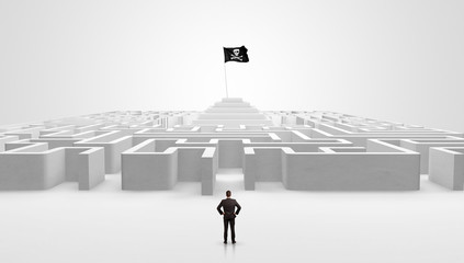 Man standing in front of a big round maze with pirate flag in the center
