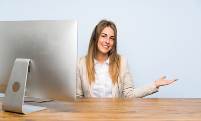 Young telemarketer woman holding copyspace imaginary on the palm