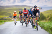 Cyclists Out Racing Along Country Lanes Near The Coast In The United Kingdom