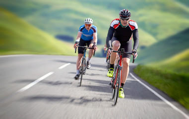 Cyclists out racing along country lanes in the mountains in the United Kingdom.