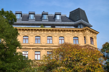 Wall Mural - Modern roof of the vintage building through trees at autumn in Vienna Austria