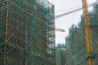 High-rise building guardrail scaffolding nets and tower cranes being built in Chinese cities