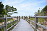 Fototapeta Pomosty - Wooden walkway leading to the beautiful beach in Brazil