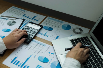  Businessman using laptop to the situation on the market value , Business concept.