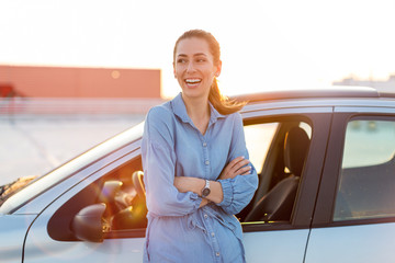 Wall Mural - happy woman driving a car and smiling