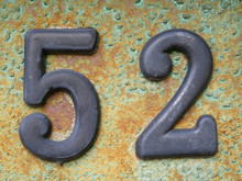 House Number Fifty Two. Old Number Fifty Two Door Plate On Old Rusty Metal Door