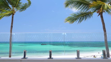 Poster - View from balcony resort on caribbean beach with coconut palm trees and tropical sea. Travel destinations. Summer vacation