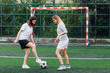 © Тарас Нагирняк - Photo of two pretty  woman playing football together on field.