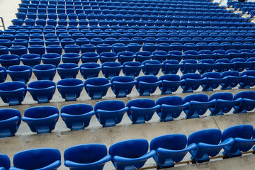 Wall Mural - Rows of blue seats in the stand in the sports arena