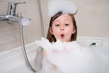 Little Girl In Bath Playing With Foam