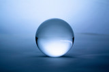 Fototapeta  - Crystal glass ball sphere transparent on blue gradient background.