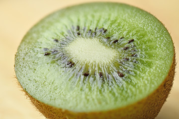 Single half of ripe juicy kiwi fruit on table