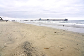 OCEANSIDE, CALIFORNIA - 2 JUNE 2019: Oceanside sea view and pier bridge playground and surfboard  