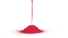 Red Sand Pouring And Making A Conical Pile On A Solid White Background