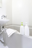 Fototapeta Panele - Bottles of shampoo and bath soap placed in the bathtub in the white bath