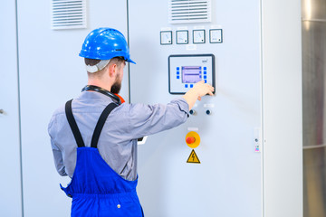 Wall Mural - worker with helmet ,ear protector and tablet computer