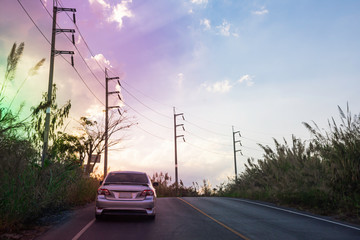 Landscape nature of the way to go to peak of mountain  Electricity pole with sunset sky clouds, Nature background with silhouette orange sky, Power transmission line in rural area