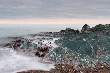 A beautiful scenery of wave splashing at the sunrise.