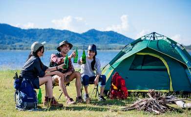 camping camp in nature happy friends party and drinking beer together in summer