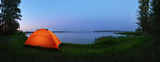 Fototapeta  - Orange tent by the lake