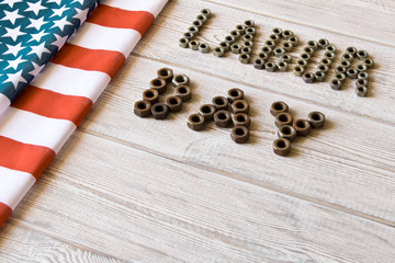 Wall Mural - Labor day. American flag and Inscription labor day on a light wooden background.