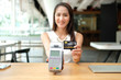 © 88studio - woman with credit card swiping machine. shopping lifestyle & payment with nfc technology