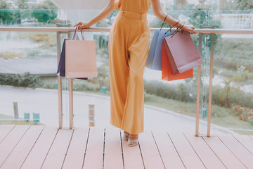 Wall Mural - woman holding shopping bags. consumerism lifestyle in mall