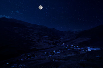 Wall Mural - mountain road through the forest on a full moon night. scenic night landscape of country road at nig