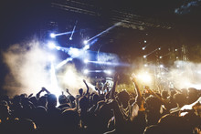 Young People Dancing And Having Fun In Summer Festival Party Outdoor - Crowd With Hands Up Celebrating Concert Event - Soft Focus On Center Hand With Yellow Background Flare - Fun And Youth Concept