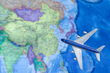 Toy plane on the map. Air trip to China. Travel by plane, booking tickets, flight by aircraft concept