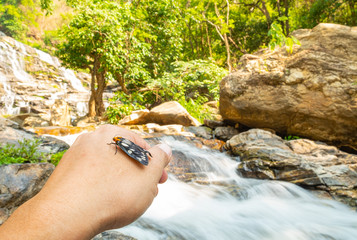 woman in waterfall in forest