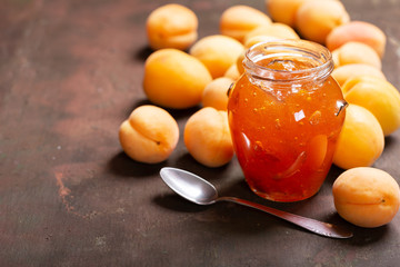 Wall Mural - glass jar of apricot jam with fresh fruits