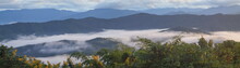 Mountain View Misty Morning Of Top Hill Around With Sea Of Mist In Valley With Cloudy Sky Background, Sunrise At Phu Chu, Sri Nan National Park, Nan, Thailand.