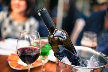 red wine on open air restaurant cafe romantic joyful young adults table