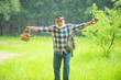© Volodymyr - Mushrooms in rainy forest. Happy Grandfather with mushrooms in busket hunting mushroom.