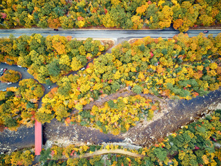 Wall Mural - Scenic highway with covered Albany Bridge at autumn in New Hampshire, USA. Fall in New England. Aerial drone shot.