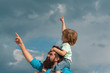© Volodymyr - Fathers day. Cute boy with dad playing outdoor. Happy child pointing on summer sky background.